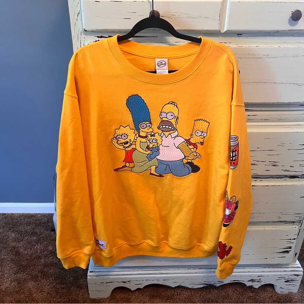 The Simpson’s Yellow Crewneck Sweater, men’s size large.